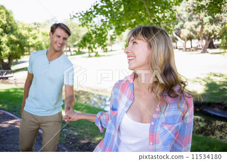Cute couple walking in the park Cute couple walking in the park 11534180