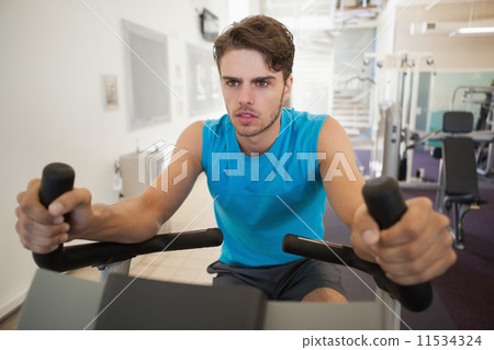 Focused fit man on the exercise bike 11534324