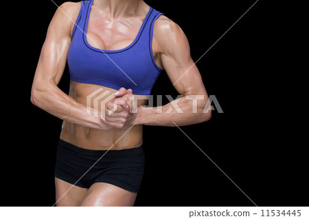 Female bodybuilder posing with hands together Female bodybuilder posing with hands together 11534445