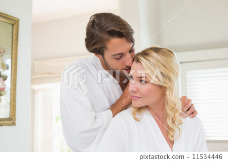 Cute couple in bathrobes spending time together Cute couple in bathrobes spending time together 11534446