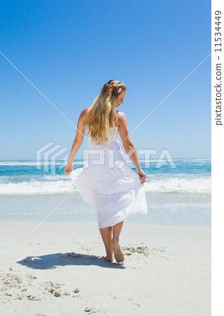 Pretty carefree blonde walking on the beach Pretty carefree blonde walking on the beach 11534449