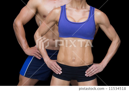 Crossfit couple posing with hands on hips Crossfit couple posing with hands on hips 11534518