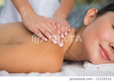 Content brunette getting a back massage Content brunette getting a back massage 11534528