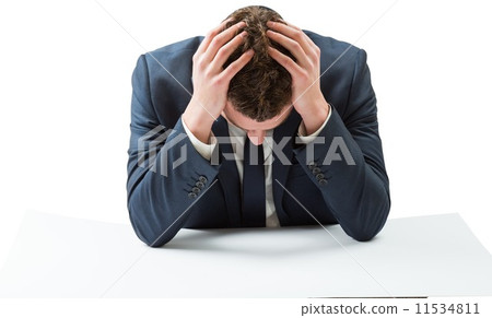 Businessman with head in hands 11534811