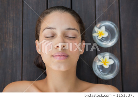 Peaceful brunette lying with eyes closed 11535373