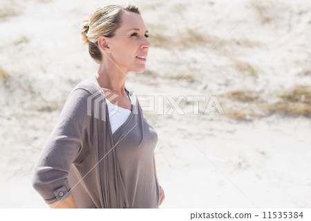 Thinking blonde woman standing on the beach Thinking blonde woman standing on the beach 11535384
