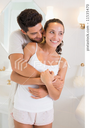 Attractive couple hugging in their pajamas Attractive couple hugging in their pajamas 11535470