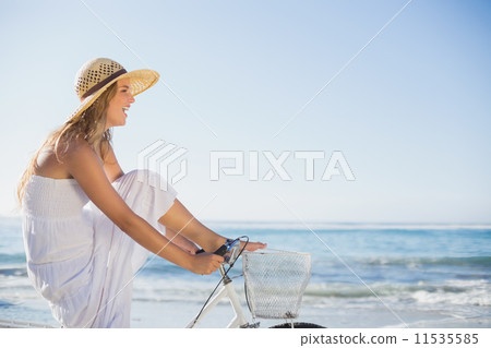 Beautiful blonde in white sundress on bike ride at the beach Beautiful blonde in white sundress on bike ride at the beach 11535585