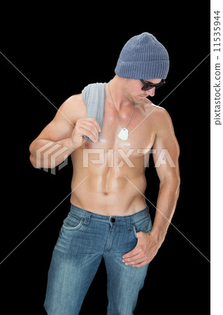 Muscular man posing in blue jeans hat and sunglasses Muscular man posing in blue jeans hat and sunglasses 11535944