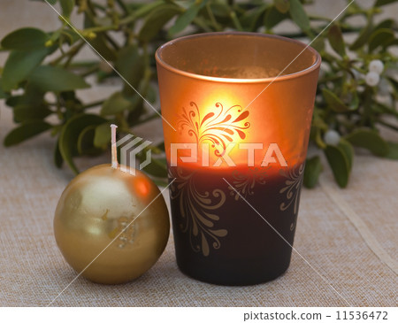 Burning candle and mistletoe Burning candle and mistletoe 11536472