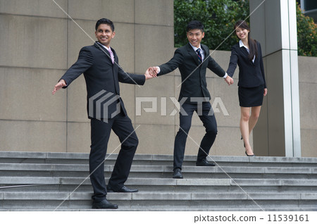 A leader leads his mult-ethnic and talented teammates by hand to walk down the stair confidently v2 A leader leads his mult-ethnic and talented teammates by hand to walk down the stair confidently v2 11539161