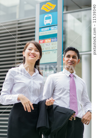 Two asian young and dynamic colleagues waiting for Singapore Public Transport Two asian young and dynamic colleagues waiting for Singapore Public Transport 11539340