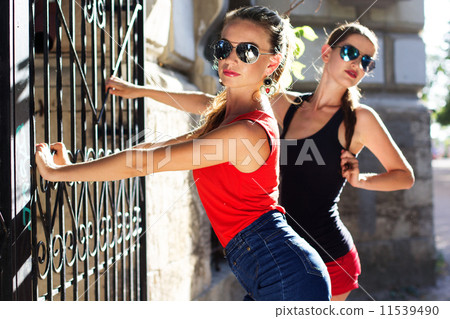 Two beautiful young women having fun in the city 11539490