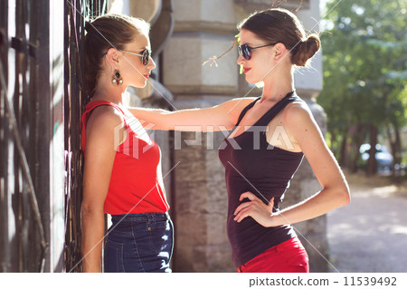 Two beautiful young women having fun in the city 11539492