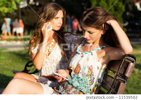 Two friends taking selfie by smartphone 11539502