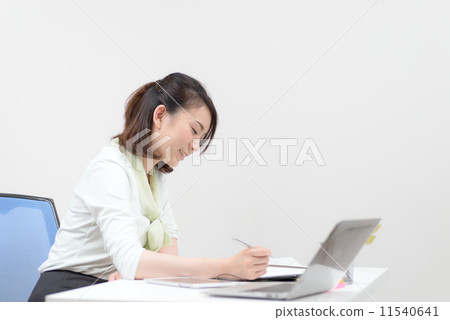 A woman writing a document A woman writing a document 11540641