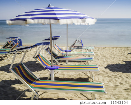 Sunbeds and umbrellas on the beach Sunbeds and umbrellas on the beach 11543104