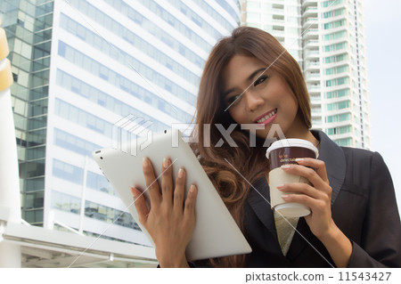 Businesswoman used tablet for search and work Businesswoman used tablet for search and work 11543427