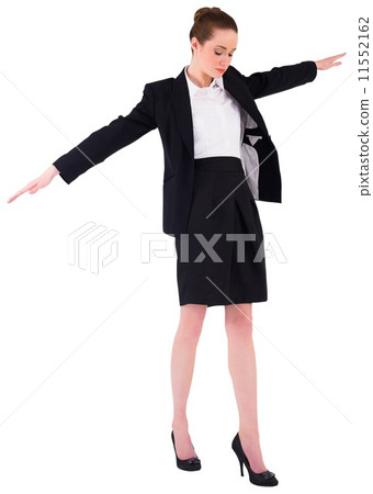 Businesswoman performing a balancing act Businesswoman performing a balancing act 11552162