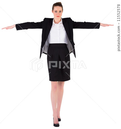 Businesswoman performing a balancing act 11552578