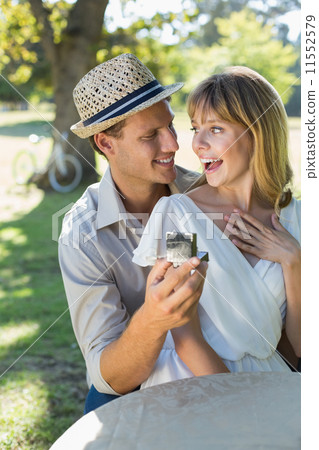 Man surprising his girlfriend with a proposal in the park 11552579