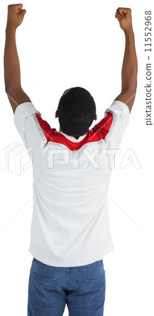 Excited handsome football fan cheering 11552968