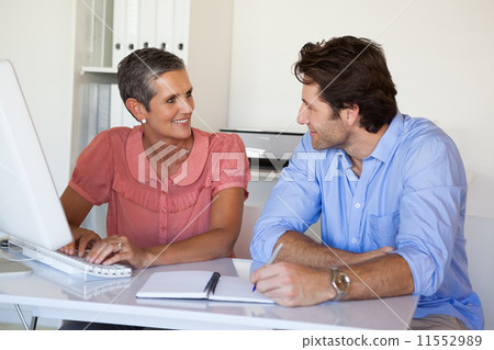 Casual happy business team having a meeting at desk Casual happy business team having a meeting at desk 11552989
