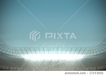Large football stadium under blue sky 11553692