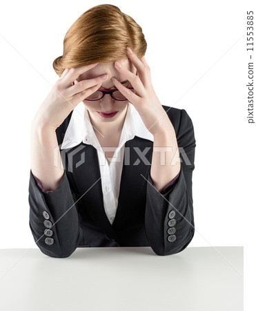 Redhead businesswoman with head in hands 11553885