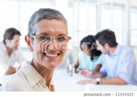 Happy businesswoman smiling at the camera Happy businesswoman smiling at the camera 11554325