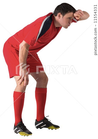 Tired football player bending over Tired football player bending over 11554331
