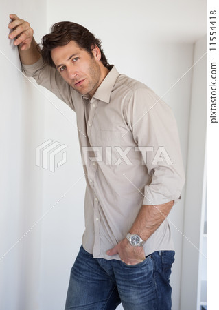 Casual worried businessman leaning on wall Casual worried businessman leaning on wall 11554418