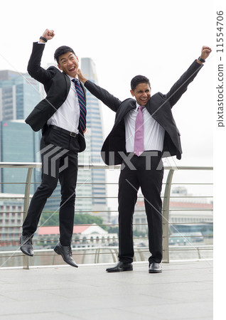 Two overjoyed partners punch their fists in the air to celebrate success of their bid Two overjoyed partners punch their fists in the air to celebrate success of their bid 11554706