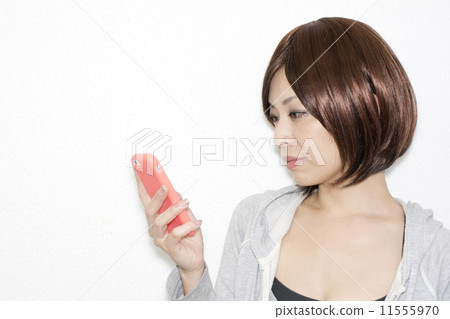 A woman watching a smartphone 11555970