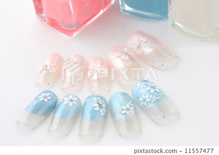 在桃紅色珍珠藍色珍珠的絲帶樣式在白色小花卉石法國釘子 11557477