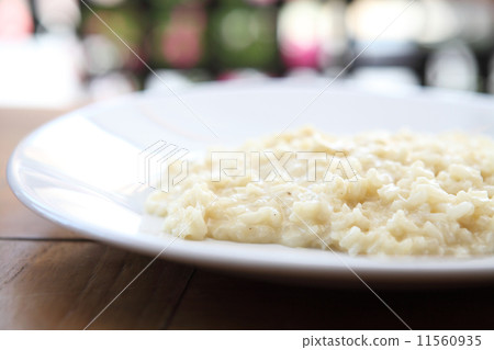risotto dish with herbs on wood background risotto dish with herbs on wood background 11560935