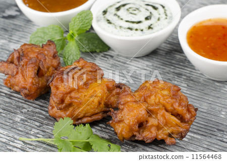 Onion Bhajis, mango chutney, mint raita & chili sauce on a slate  11564468