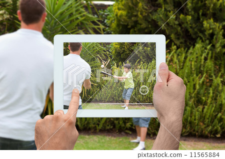 Composite image of hand holding tablet pc Composite image of hand holding tablet pc 11565884
