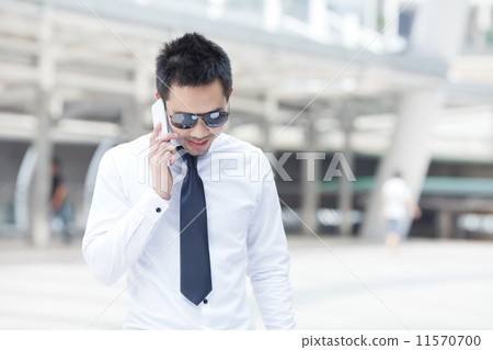 Asian business man speaking mobile phone 11570700