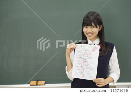 A high school student standing in front of the blackboard 11571626