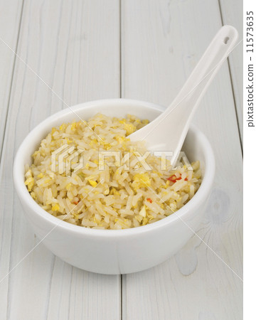 Oriental egg fried rice on a wooden table Oriental egg fried rice on a wooden table 11573635