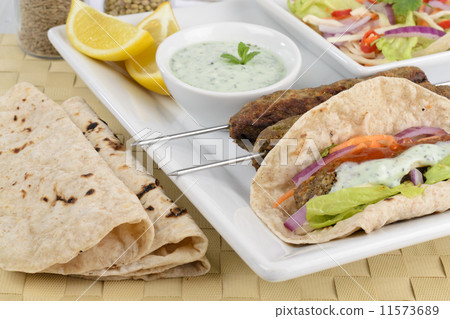 Seekh Kebab -Minced meat kebab with chili sauce, raita & chapati Seekh Kebab -Minced meat kebab with chili sauce, raita & chapati 11573689