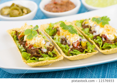 Shredded beef taco trays with salsa, sour cream and cheese Shredded beef taco trays with salsa, sour cream and cheese 11576933