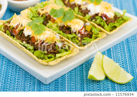 Shredded beef taco trays with salsa, sour cream and cheese Shredded beef taco trays with salsa, sour cream and cheese 11576934