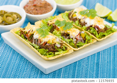 Shredded beef taco trays with salsa, sour cream and cheese Shredded beef taco trays with salsa, sour cream and cheese 11576935