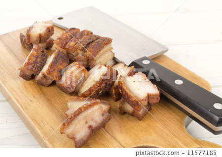 Siu Yuk - Chinese roast pork belly on a board with a cleaver Siu Yuk - Chinese roast pork belly on a board with a cleaver 11577185