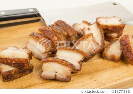 Siu Yuk - Chinese roast pork belly on a board with a cleaver Siu Yuk - Chinese roast pork belly on a board with a cleaver 11577186