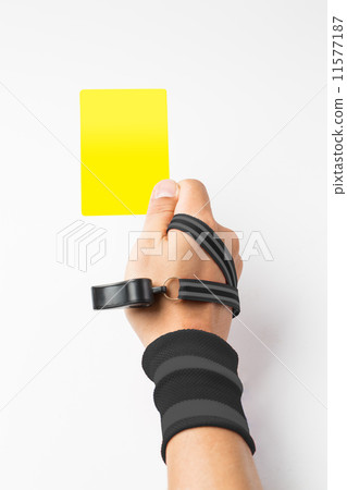 Referee hand and whistle show Yellow card to player Referee hand and whistle show Yellow card to player 11577187