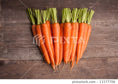 fresh carrot bunch on grungy wooden background fresh carrot bunch on grungy wooden background 11577706