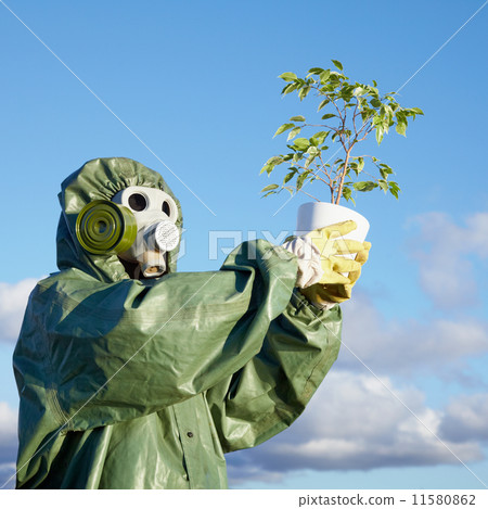 Man in chemical suit and gas mask with plant in hands Man in chemical suit and gas mask with plant in hands 11580862